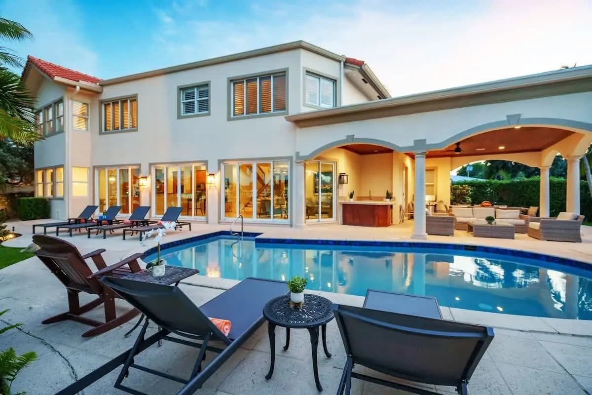 Waterfront home with a pool and patio at Intracoastal Elegance